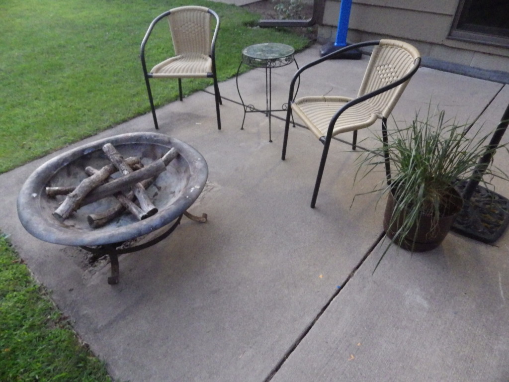 patio fire pit wicker chairs and potted plant