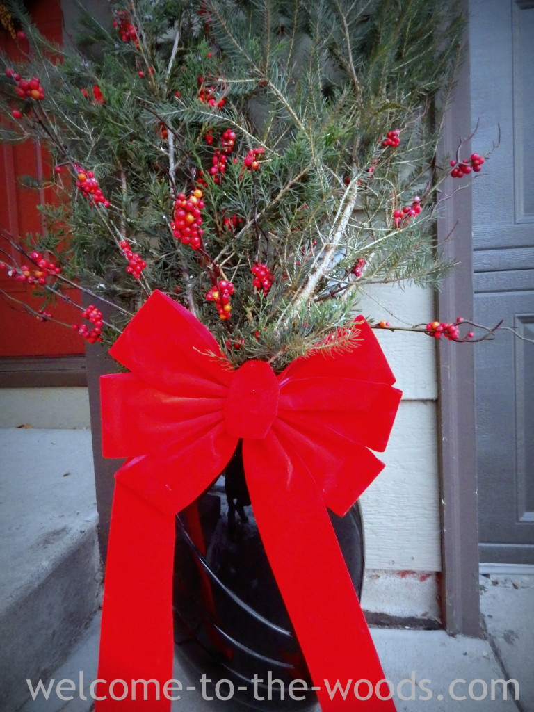 red bow evergreen front entrance Christmas display