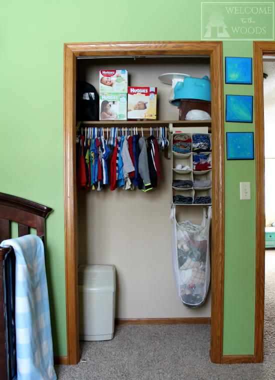 Baby clothes organized in small closet