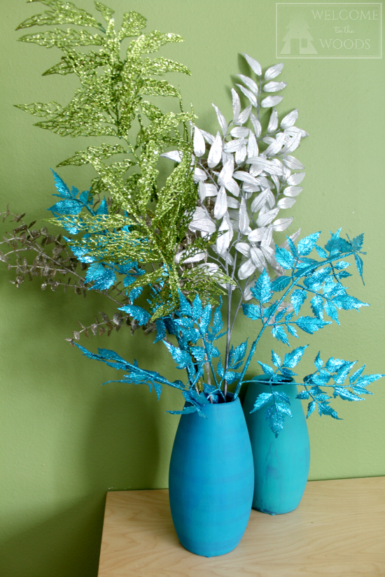 Glittery branches blue, silver, and green in turquoise vase