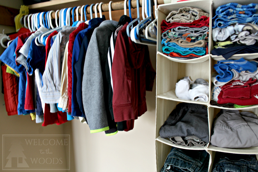 Baby clothes organized hanging in closet, folded into shoe organizer