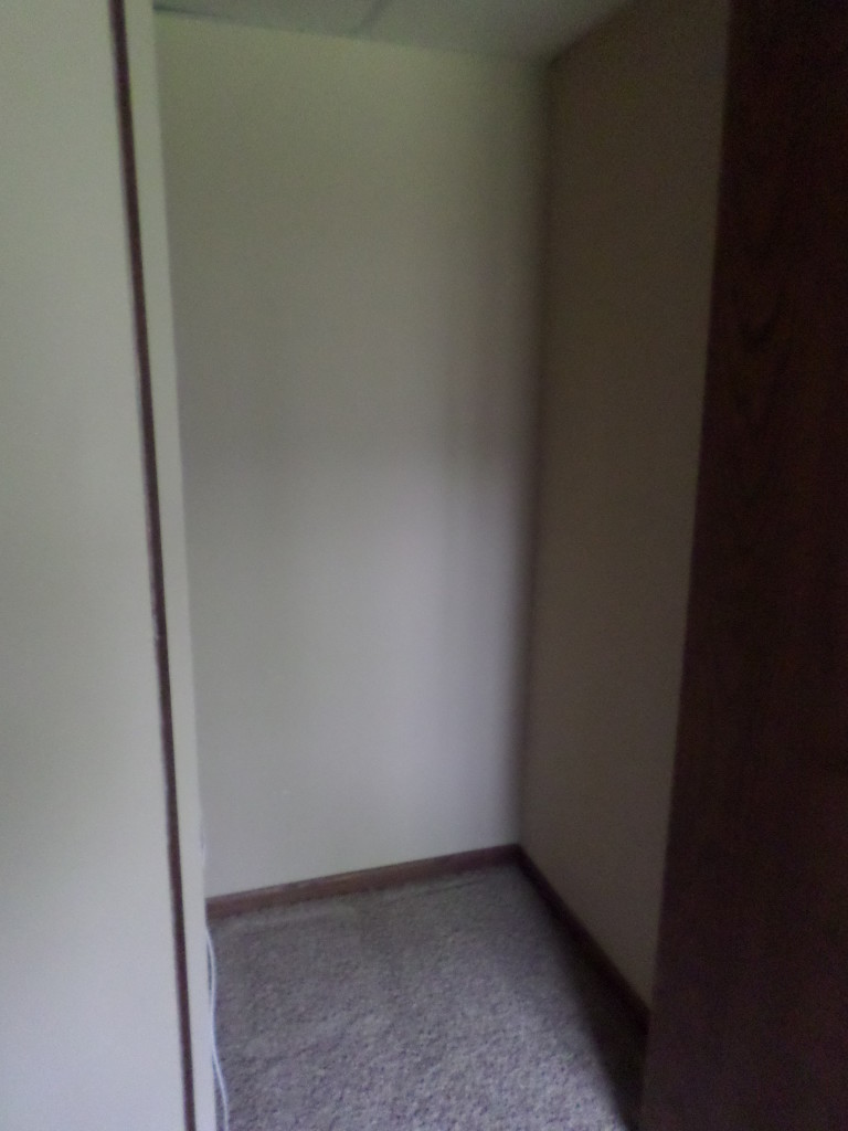 empty deep closet waiting for shelves to utilize storage space