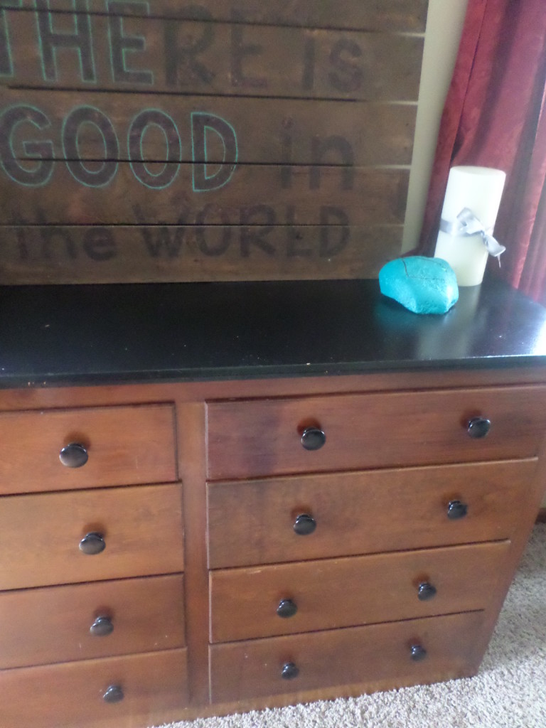 dresser used as a pantry to store food in small kitchen