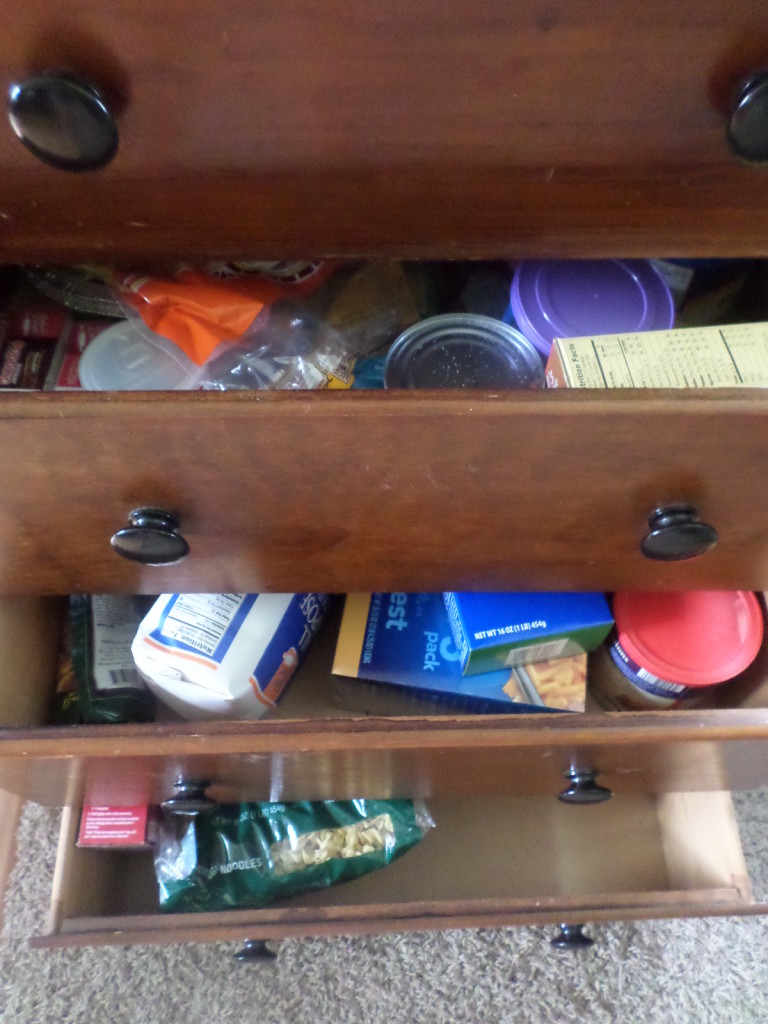 dresser filled with food used as a pantry storage solution