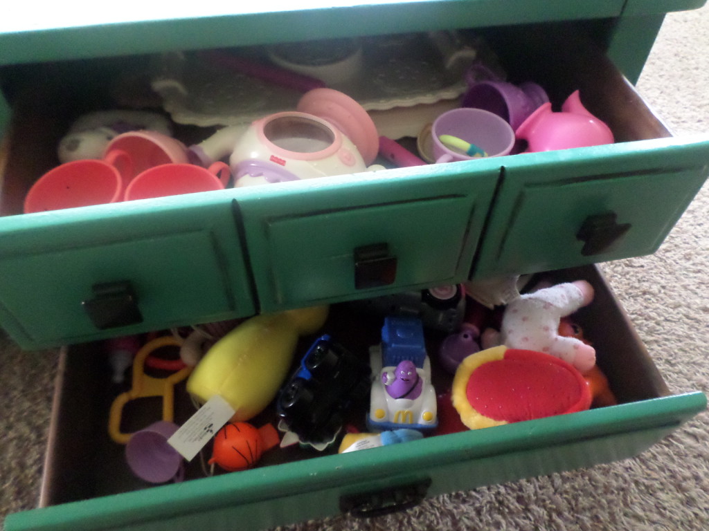 Store childrens toys in coffee table drawers in living room