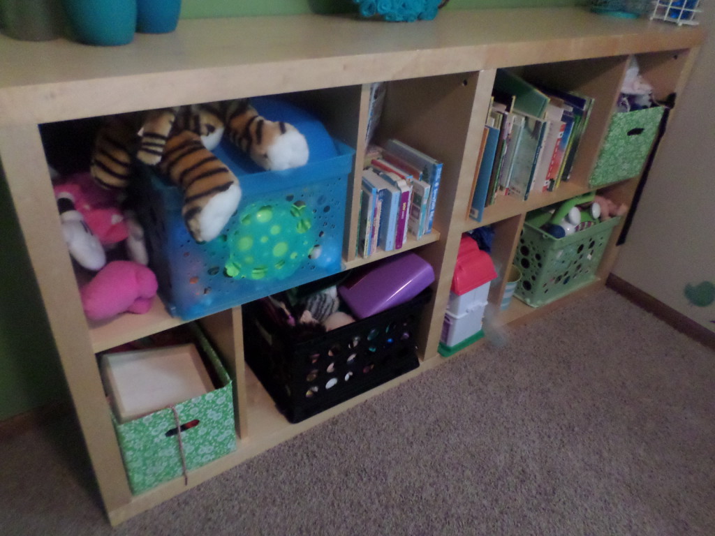 Utilize large bookshelf to organize all toys and books for storage in your house