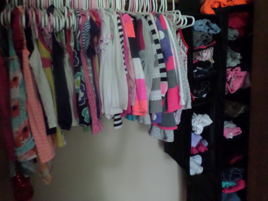 Use a shoe organizer to keep all your baby clothes stored in the closet.