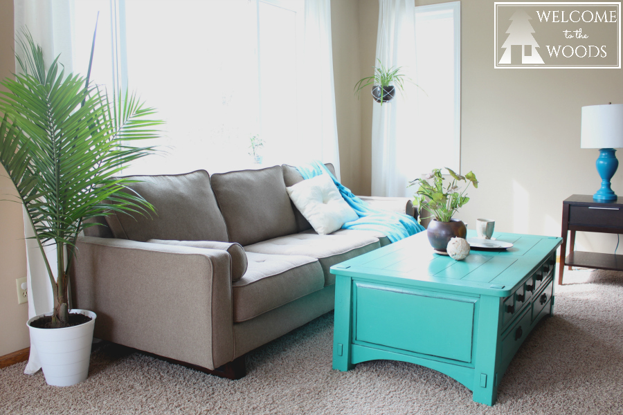 I love this modern couch, especially against the white curtains and big window letting lots of light into this living room design.