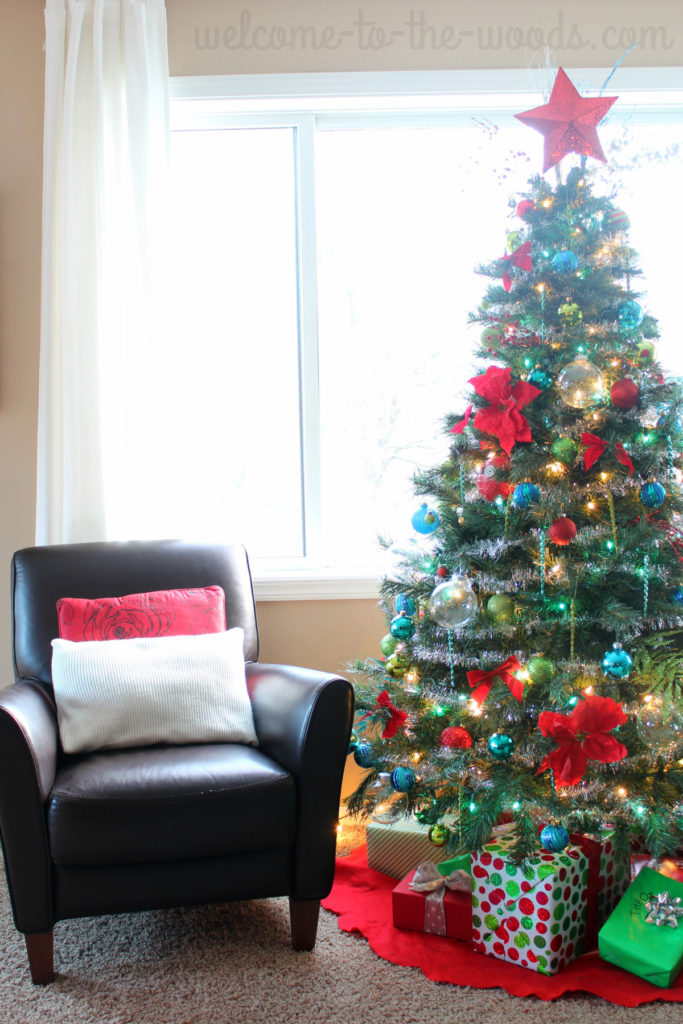 Beautiful, colorful Christmas tree in this living room holiday decor. Click to see the whole home holiday tour!