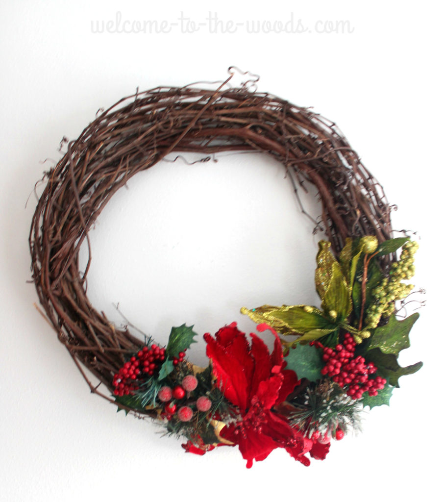 Poinsettia winter Christmas grapevine wreath, glittery branches and cranberry details.