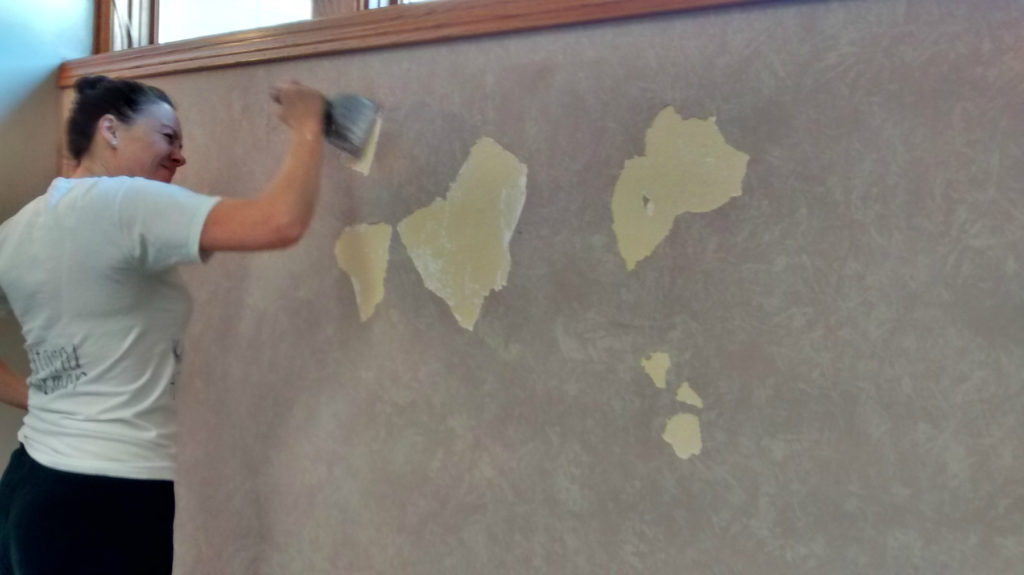 Use a drywall knife to chip off plaster.