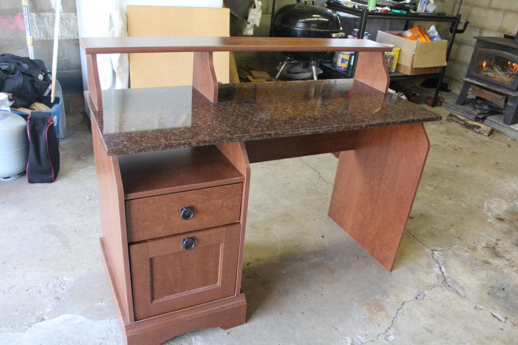 Old desk revamped into a pallet wood reception desk.