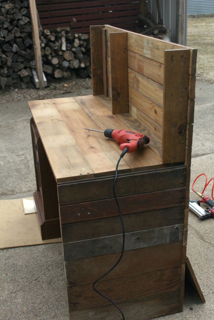 Cover existing piece of furniture with reclaimed barn wood for an industrial chic look.