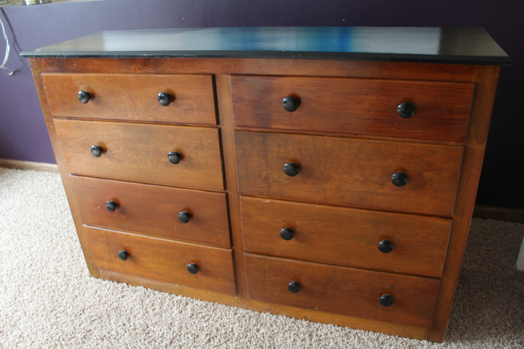 Old dresser with outdated knobs.