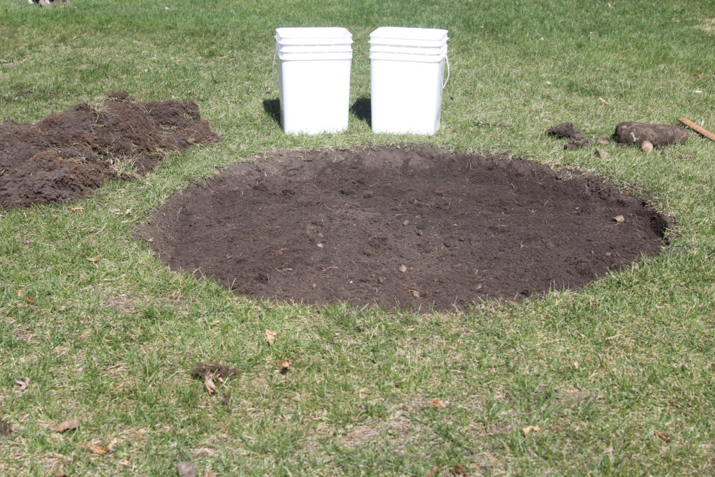 When you're completely done removing sod from the circle, level the area and dump sand over top.