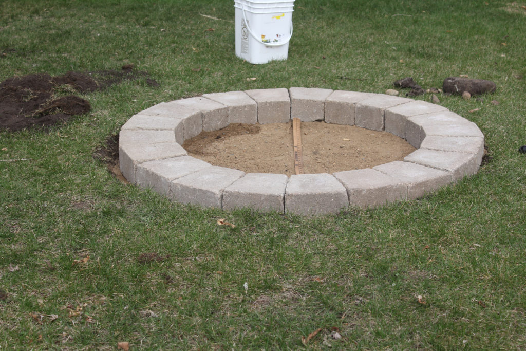 The first layer of fire pit construction is the hardest! Get all the info and tips you need in my video tutorial.