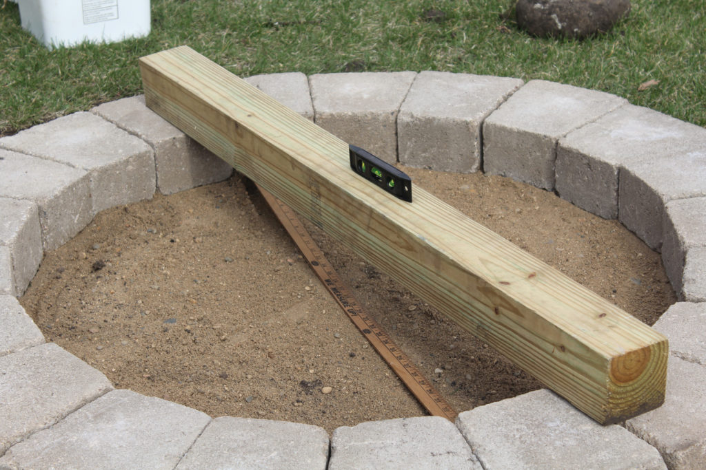 Ensure the first layer of cement blocks for your fire pit is completely level.