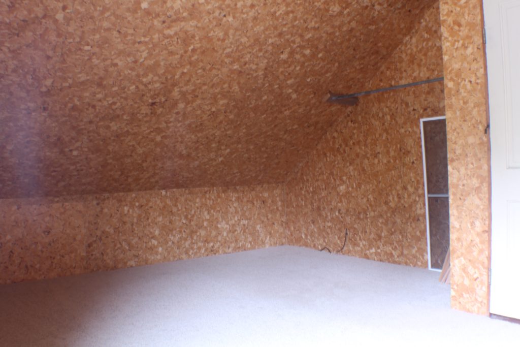 Plywood chipboard walls. This shell of a space gets turned into an amazing colorful kids bedroom!